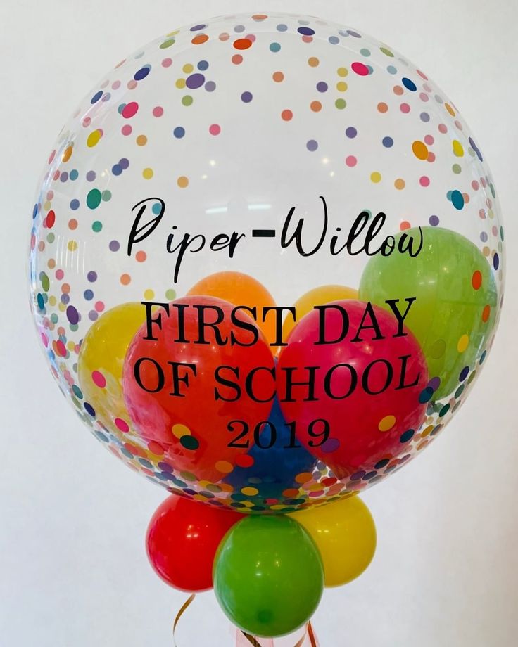 a bunch of balloons with the words paper - willow first day of school on them