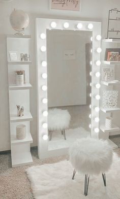 a room with a mirror, stool and lights