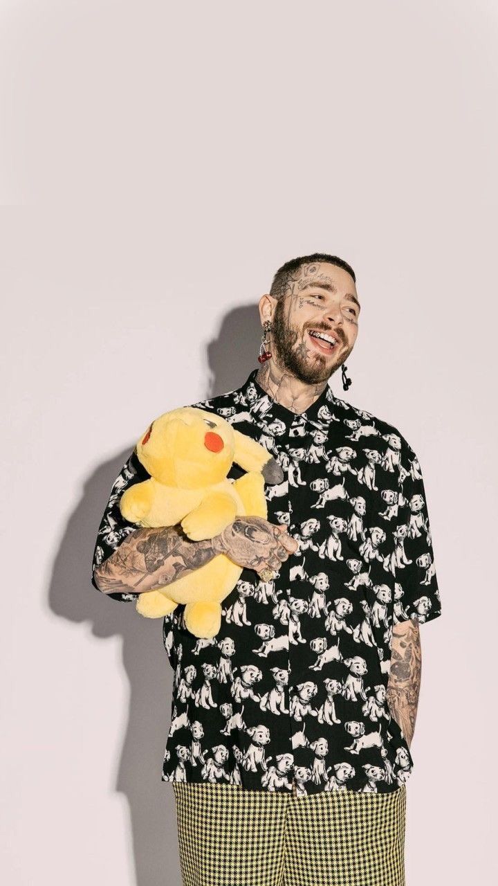 a man holding a yellow stuffed animal in his right hand