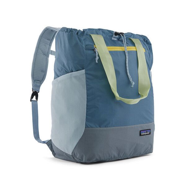 a blue and grey backpack with yellow straps on the front, sitting against a white background