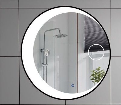 a bathroom mirror with the reflection of a shower head in it's circular frame