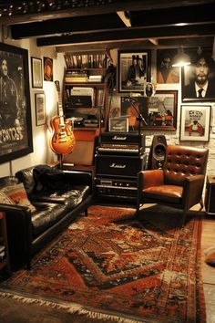 a living room filled with lots of furniture and pictures on the wall next to a guitar