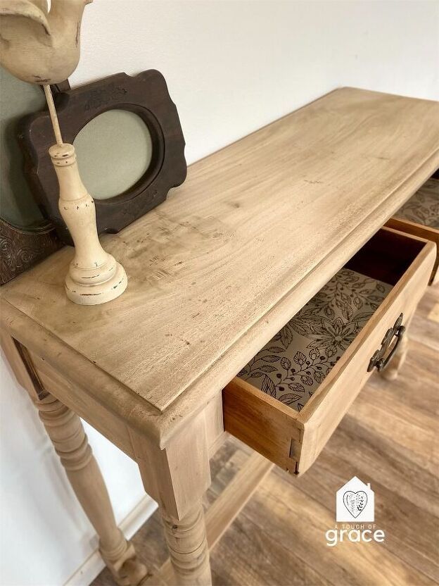 a wooden table with two drawers and a mirror on top