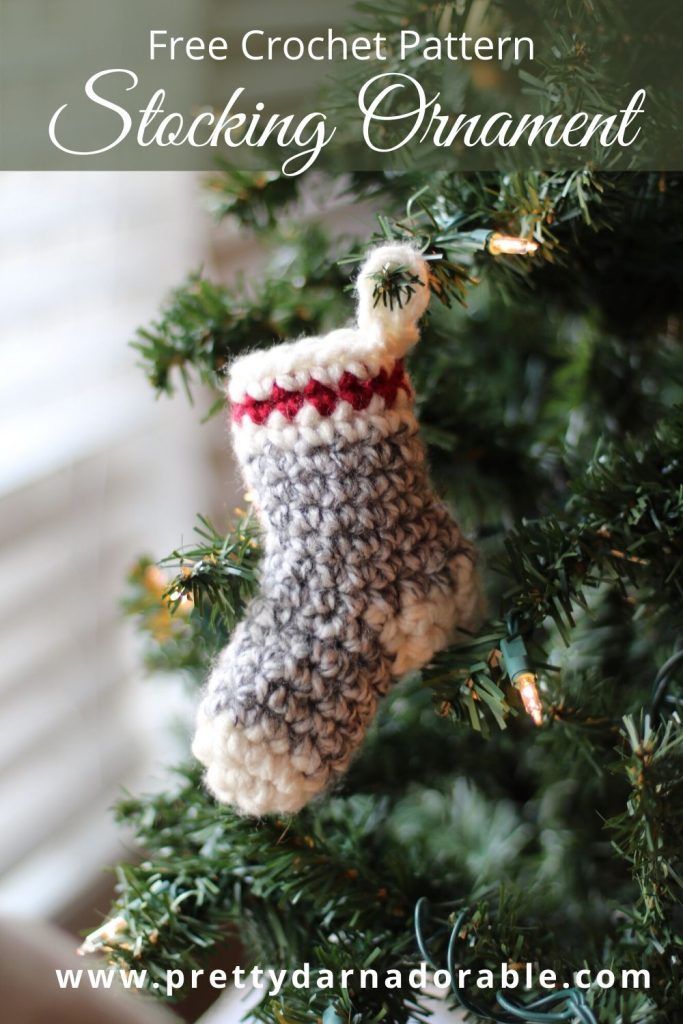 a crocheted stocking ornament hanging from a christmas tree with the text free crochet pattern