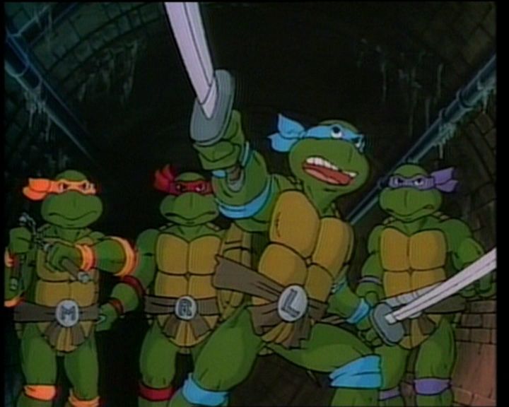 the teenage mutant turtles are holding up their swords