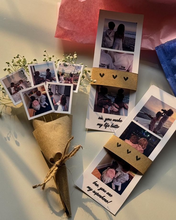 an arrangement of pictures and flowers on a table