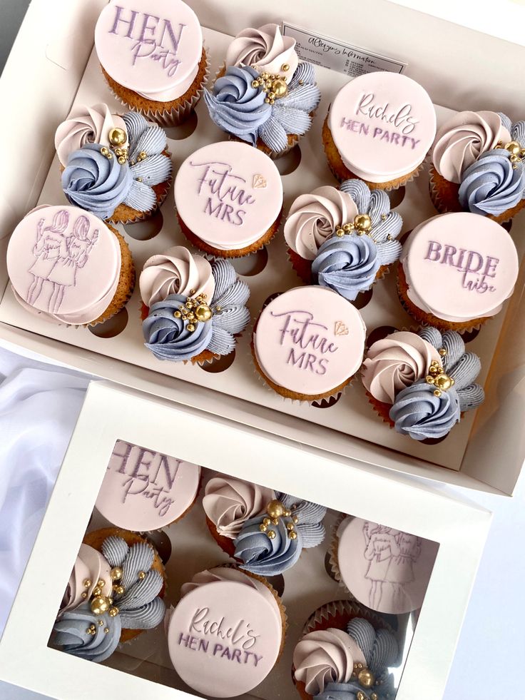 cupcakes with pink and blue frosting in a box