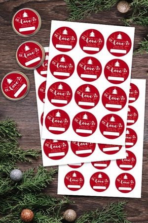 red stickers with the words love and christmas trees on them, surrounded by pine branches