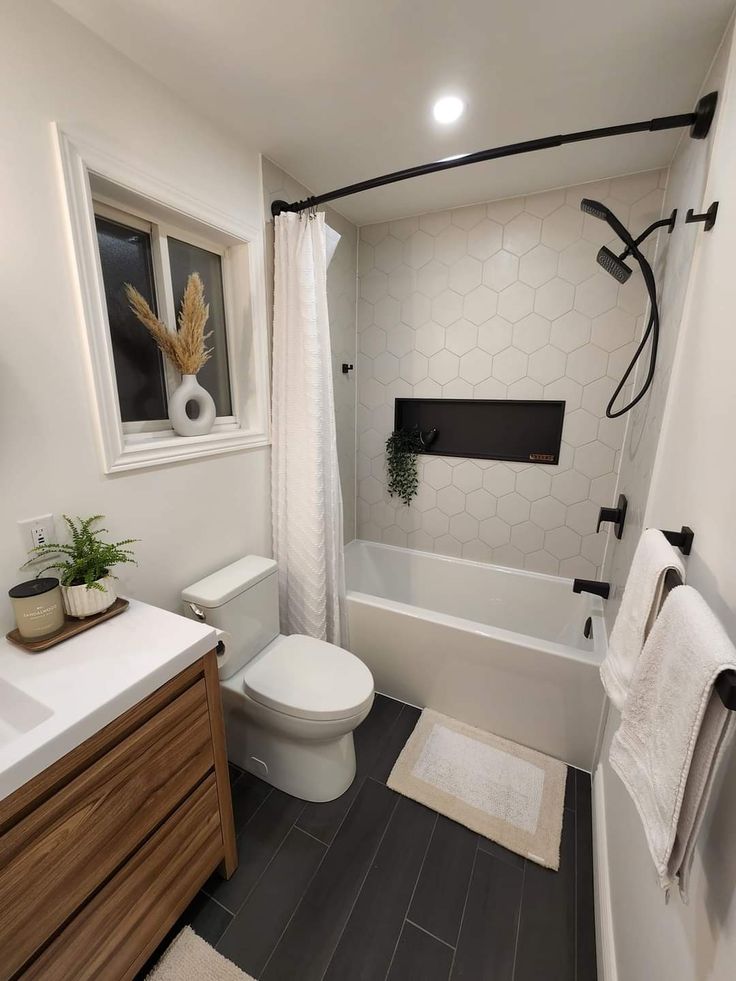 a bathroom with a toilet, sink and bathtub