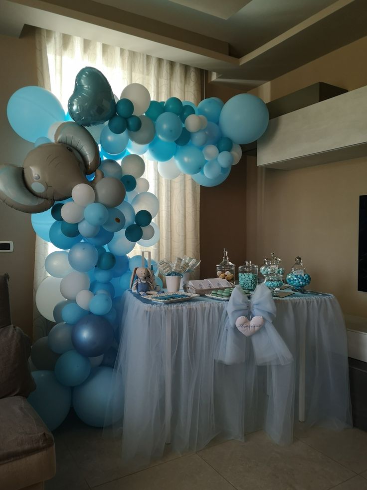 a table with balloons and decorations on it