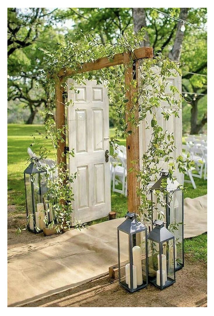 an outdoor ceremony set up with lanterns and greenery