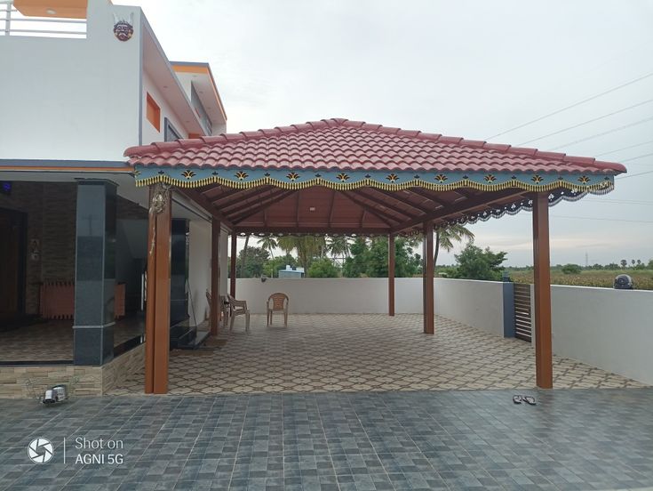 an outdoor covered patio with table and chairs