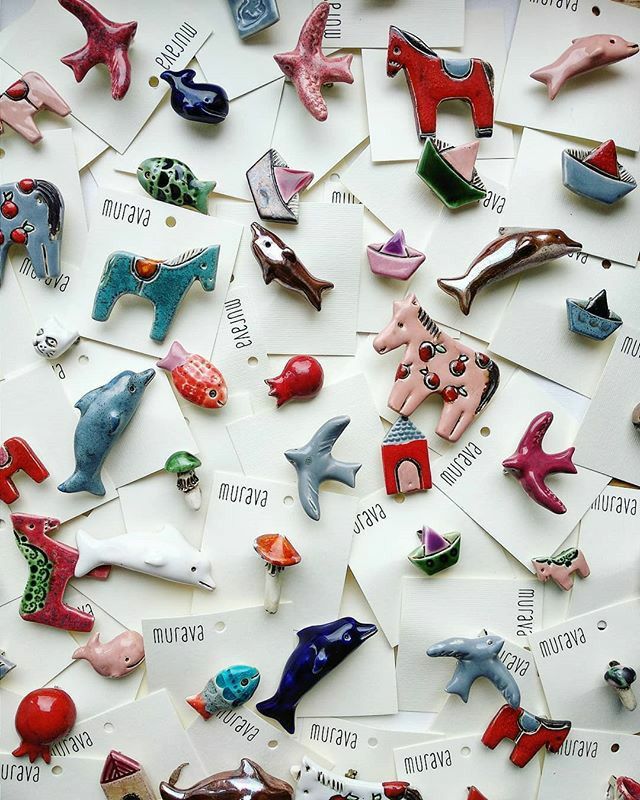 there are many different types of magnets on the table together, including dolphins and fish