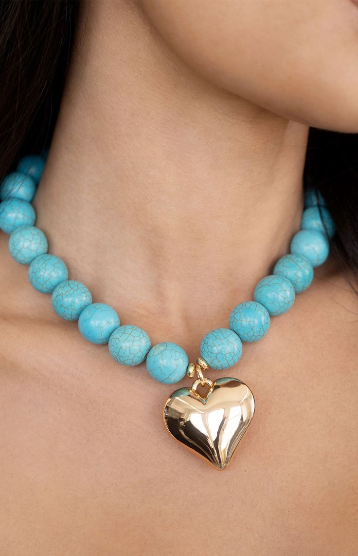 Online Only! Embrace effortless charm with Ettika's Luck & Love Turquoise Beaded Choker Necklace, featuring a captivating turquoise beaded chain adorned with a radiant gold heart pendant. 


	18k gold plated
	Reconstructed turquoise beads
	15" with 3" extender
	Lobster clasp closure Blue Heart-shaped Beaded Chain Jewelry, Turquoise Beaded Heart Pendant Jewelry, Turquoise Heart-shaped Gemstone Bead Jewelry, Blue Jewelry With Heart Charm And Round Beads, Turquoise Heart Charm Pendant Necklace, Turquoise Pendant Necklace With Heart Charm, Turquoise Heart Beaded Necklaces As Gift, Heart-shaped Turquoise Beaded Jewelry, Turquoise Heart-shaped Beaded Necklace Gift