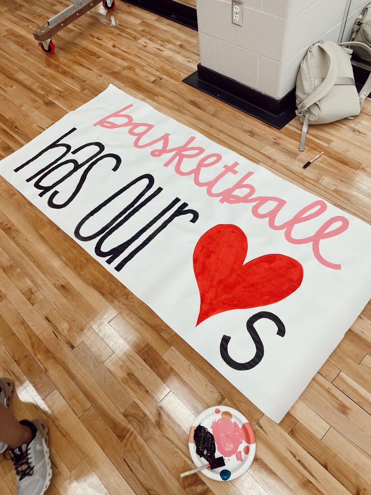 a basketball court mat with the words basketball is our s and a heart on it