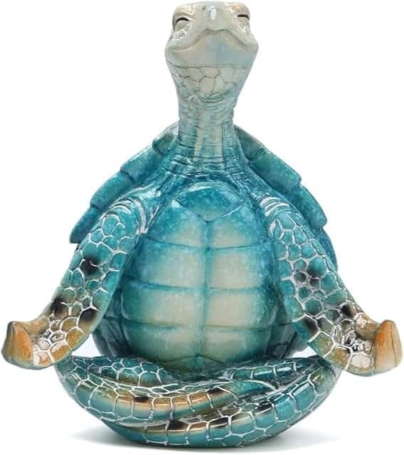 a statue of a turtle sitting on top of it's back with its eyes closed