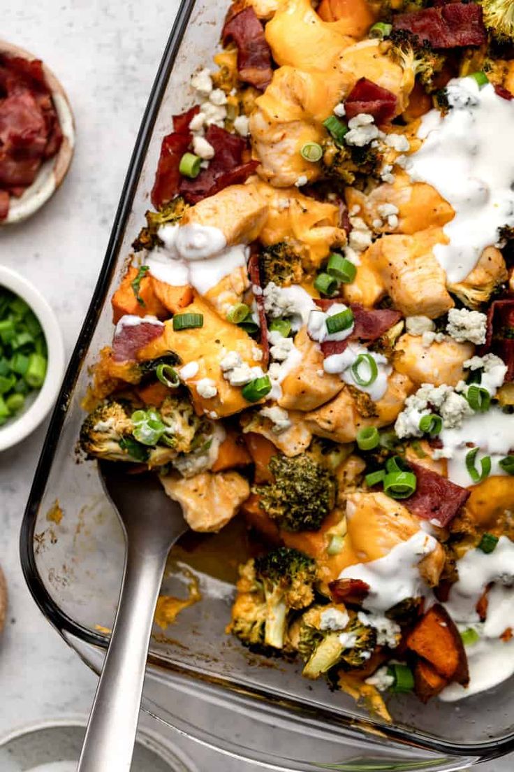 a casserole dish with broccoli, chicken and cheese