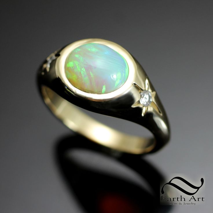 It's no secret that I love opals and will buy up small parcels of them when I come across well cut stones.  This stone came from an older parcel that was mined and cut in Australia several decades ago and is still just as beautiful the day it was cut. The ring features a solid natural Australian opal cabochon Weight: 1.95 carats The ring is a size 7.5 Solid 14k Yellow gold Natural Diamonds on the sides, nested within bright cut 6 rayed stars. 0.07 cttw The ring is open on the inside to the back of the opal. This is a one of a kind ring. Ready to ship. You'll receive the exact ring pictured. Cheers, Austin 14k Gold Opal Ring With Polished Finish For Anniversary, Opal Cabochon Ring In 14k Gold For Anniversary, Heirloom Opal Ring With Polished Finish, 14k Gold Opal Ring With Polished Finish For Promise, 14k Gold Cabochon Opal Ring For Anniversary, Unique Untreated Opal Ring For Anniversary, Celestial Oval Opal Ring For Anniversary, 14k Gold Cabochon Opal Anniversary Ring, Unique 14k Gold Hallmarked Opal Ring