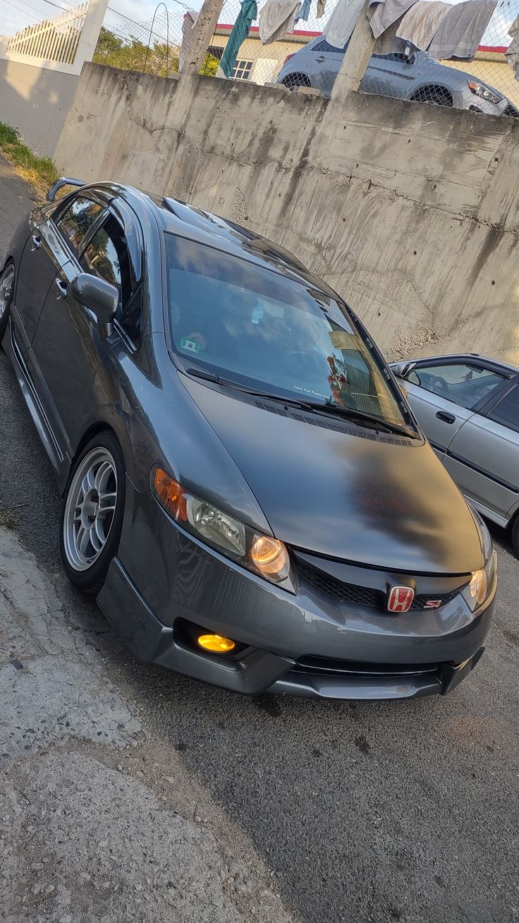 a gray car parked on the side of a road