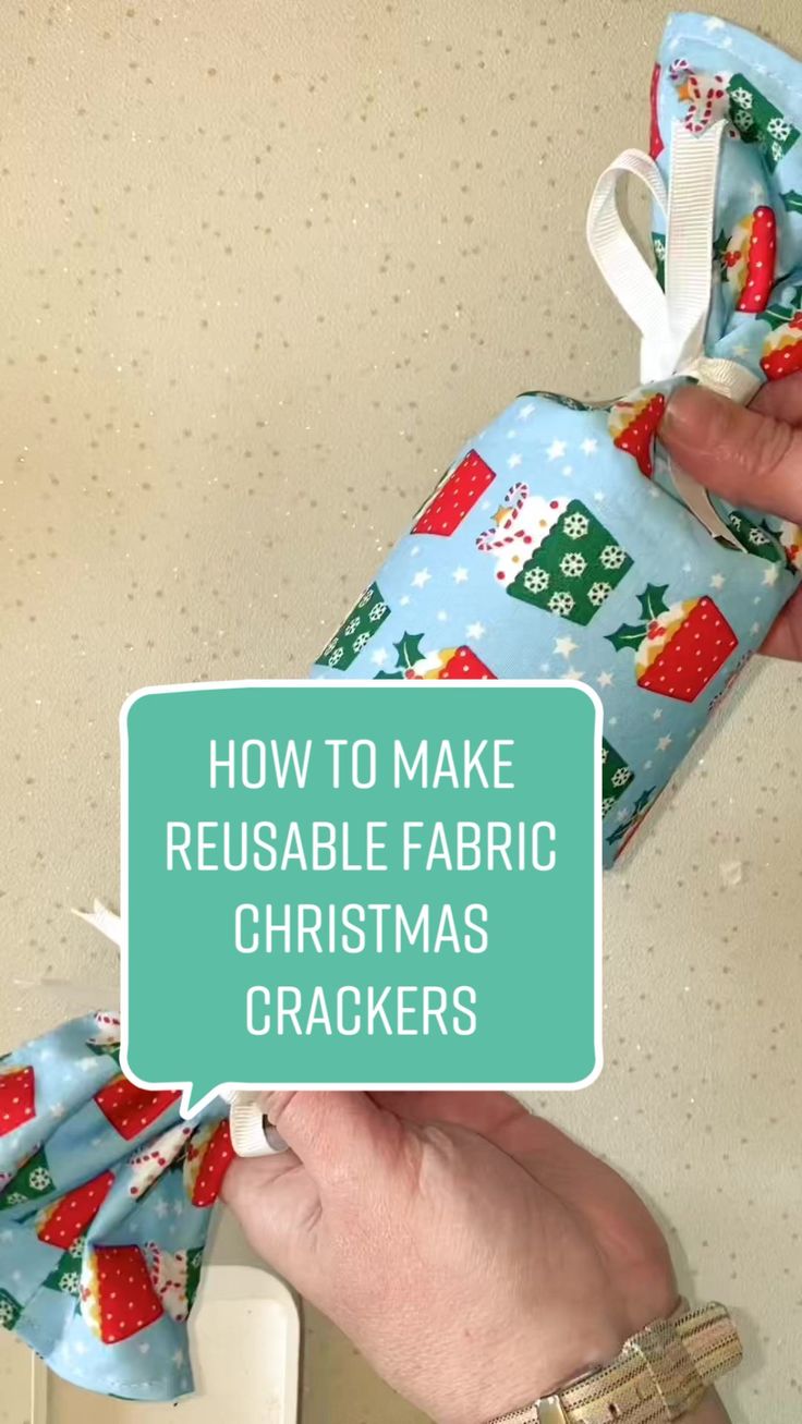 a person is wrapping fabric around a christmas cracker with the words how to make reusable fabric christmas crackers