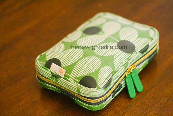 a green and white case sitting on top of a wooden table