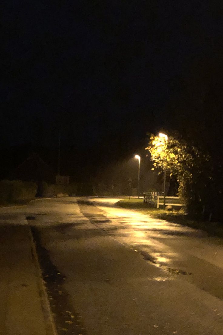 an empty street at night with the lights on