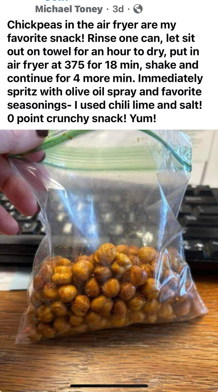 a bag filled with chick peas sitting on top of a wooden table next to a keyboard