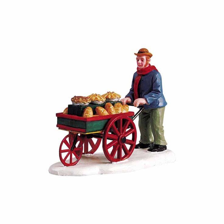 a figurine of a man pushing a wagon filled with pastries