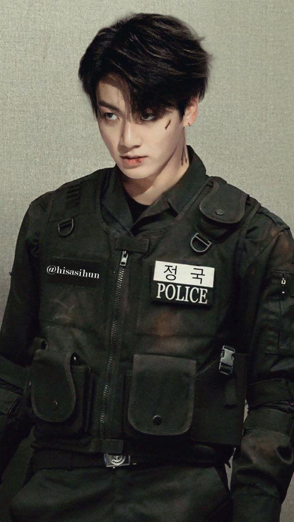 a man with black hair wearing a police uniform