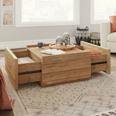 a wooden coffee table with drawers on top