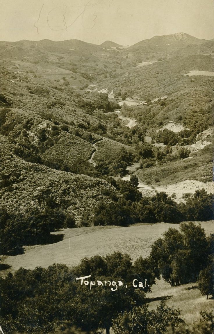 an old black and white photo of a valley