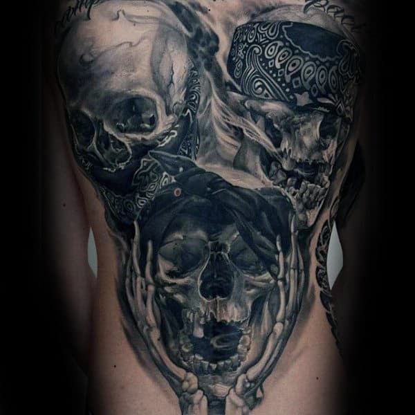 a man's back with skulls and bones on it