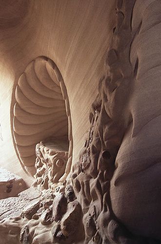 an intricately carved sand sculpture in the shape of a spiral staircase