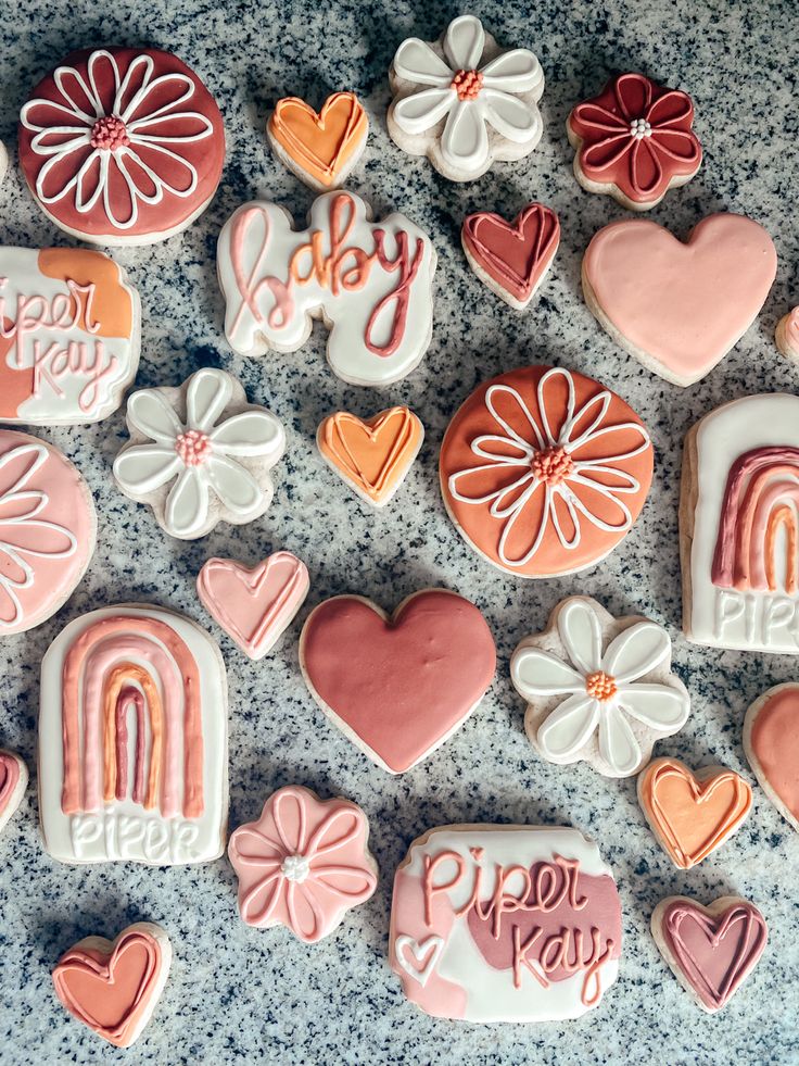 many decorated cookies are arranged on the table