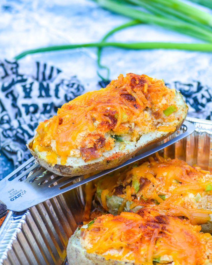 two pieces of bread with cheese and other toppings in a metal pan on a table