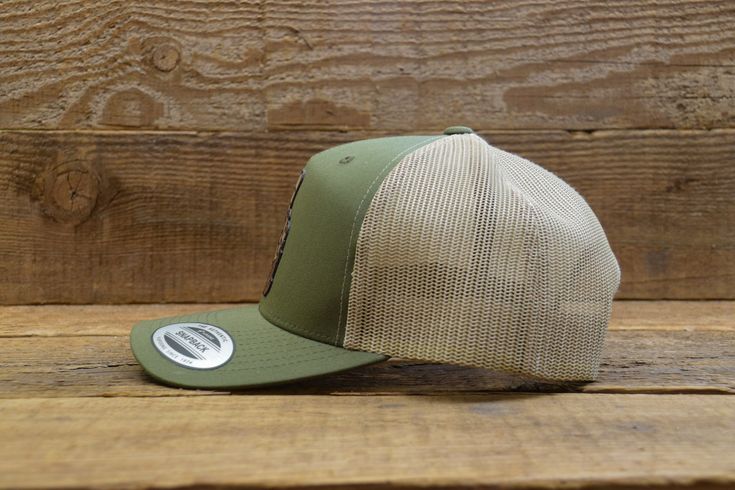 "Snap back Yupoong cap with \"Sasquatch Department\" Patch. One size fits all. Adjustable for hat sizes 6-5/8 to 7-5/8 The front panels are cotton, and the mesh back is polyester. Available in: OD Green w/ Tan Mesh" Khaki Trucker Baseball Cap, Khaki Trucker Style Baseball Cap, Khaki Trucker-style Baseball Cap, Khaki Trucker Baseball Cap For Outdoor, Khaki Trucker Snapback Hat For Outdoor, Green Mesh Hat For Outdoor, Khaki Trucker Hat For Outdoor, Green Mesh Outdoor Hat, Fitted Outdoor Cap