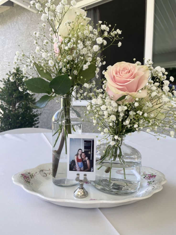 two vases filled with flowers on top of a table