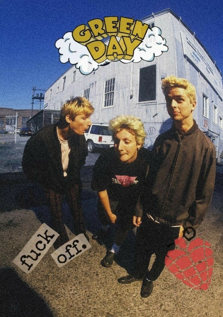 three young men standing next to each other in front of a building with the words green day on it