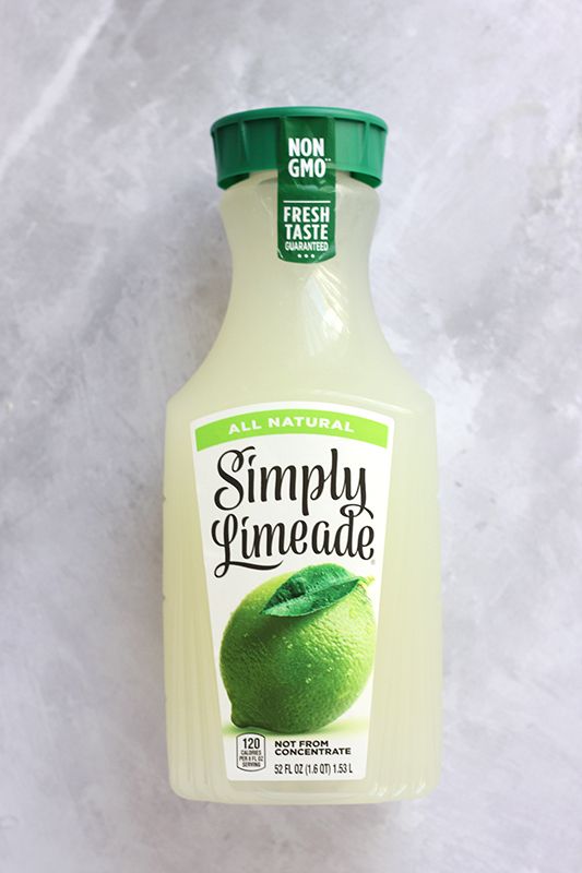 a bottle of simply limeade on a white surface