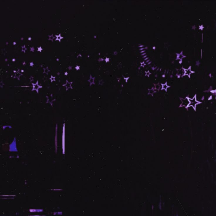 purple stars are flying in the air above a black background with white and blue lights