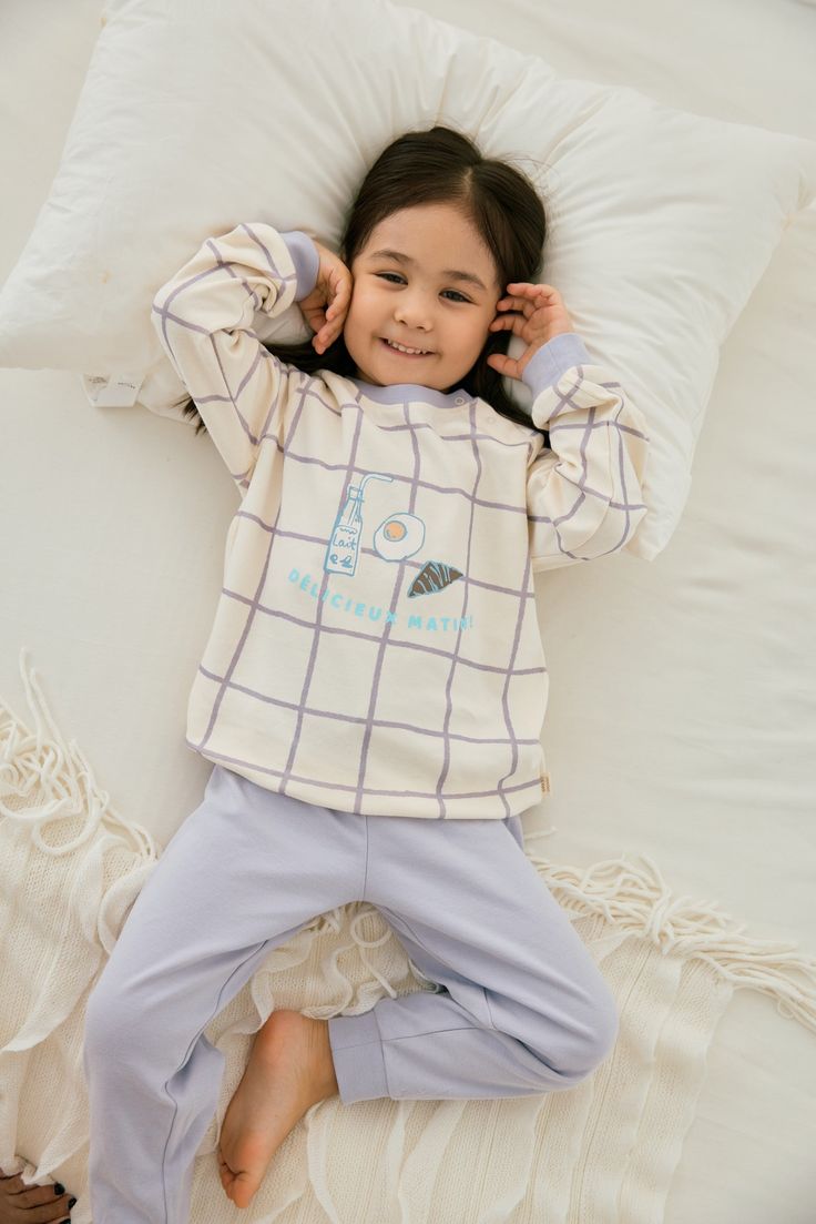 Pajama sets come in ultra-soft organic cotton with a long-sleeve top and bottom. Two snap buttons at the front for easy pulling on. Featuring a cute mikly breakfast pattern print. The essential comfy and healthy apparel for kids to wear at home. -Made of 100% GOTS-Certified organic cotton -Color: Milky Family Matching Cotton Bedtime Tops, Family Matching Cotton Tops For Pajama Party, Comfortable Cotton Long Sleeve Sets, Cozy Cotton Bedtime Sets, Cozy Long Sleeve Sleepwear, Organic Cotton Cream Tops For Loungewear, Cute Loungewear Sets With Long Pants, Comfortable Long Sleeve Top For Pajama Party, Cozy Cotton Tops For Sleepovers