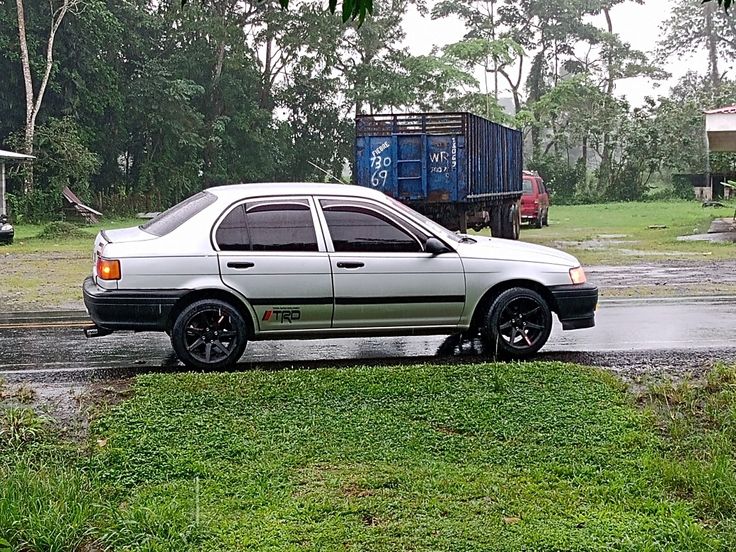 a white car parked on the side of a road