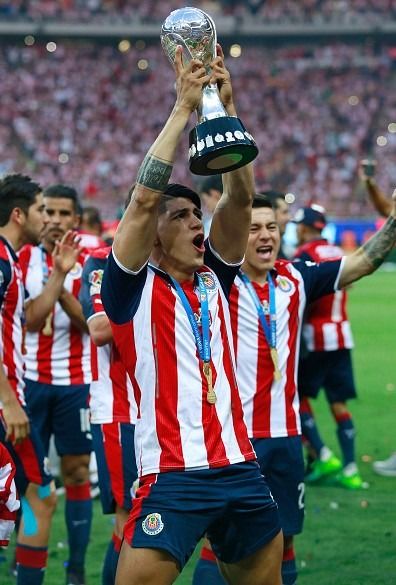 the soccer players are celebrating with their trophy