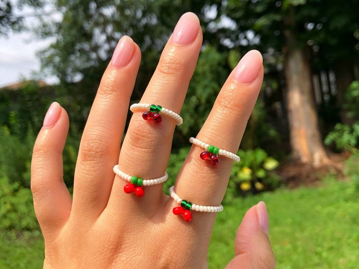 D E T A I L S These dainty cherry rings are so cute and fun! They are perfect to have matching rings with your friends and loved ones, or have multiple options for yourself to go with different outfits and for ring stacking. Choose between multiple colours for the ring band (~2mm beads) and 2 colourways for the cherries (3-4mm beads). Pull your look together with the matching bracelet, plus a classic cherry choker that can be found in my shop (link below!). I also recommend minimizing contact wi Cherry Seed Bead Ring, Matching Beaded Rings, Cherry Seed Bead, Cherry Rings, Cherry Ring, Seed Bead Ring, Bead Rings, Aesthetic 90s, Cute Aesthetic