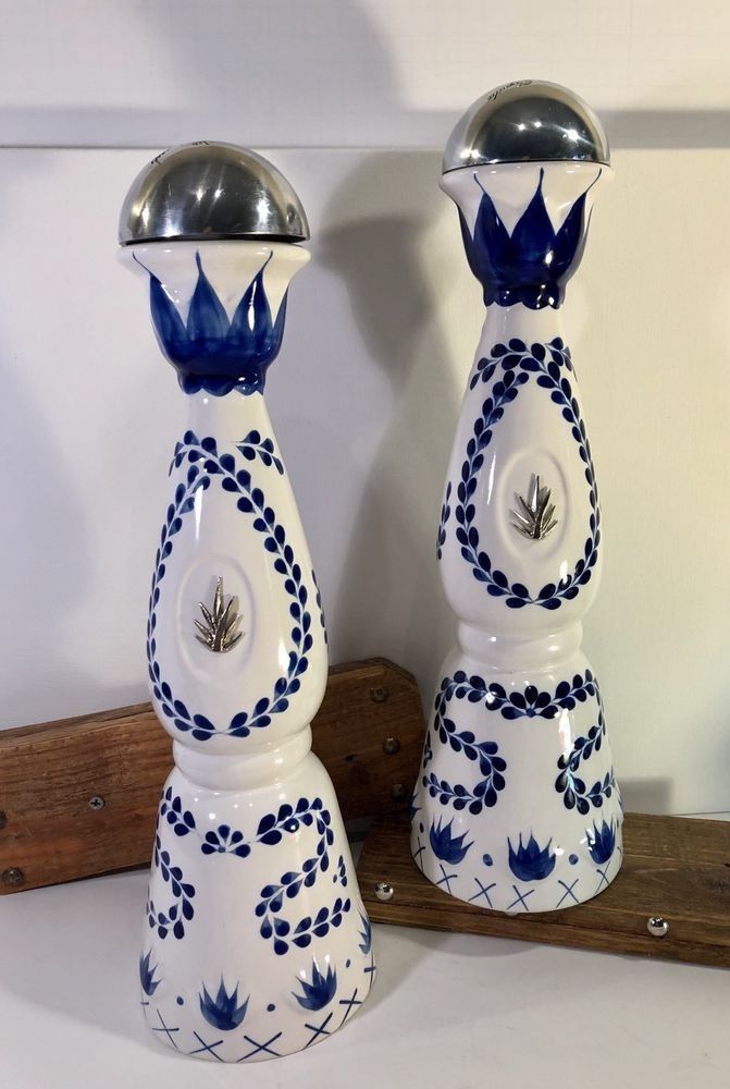 two blue and white vases sitting next to each other on a wooden table top