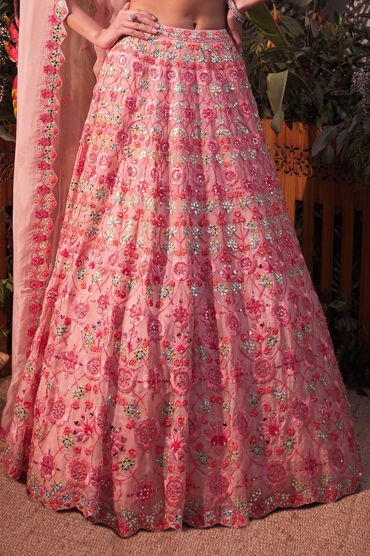 Pink lehenga with mirror work, multicolor thread and sequin work. Comes with blouse and dupatta.
Component: 3
Pattern: Embroidery
Type Of Work: Mirror, Thread and Sequin
Neckline: V neck
Sleeve Type: Sleeveless
Fabric: Organza
Color: Pink
Other Details: 
Scallop detail on the neckline and hem
Dupatta with scallop and cutwork border
Closure: Hook front
Note: Light pink lehenga worn by the other model is not for sale
Occasion: Bride - Aza Fashions Lehenga With Mirror Work, Light Pink Lehenga, Embroidery Mirror, Organza Embroidery, Pink Lehenga, Pink Mirror, Luxury Sale, Pattern Embroidery, Mirror Work