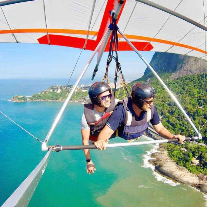 two people are parasailing over the ocean