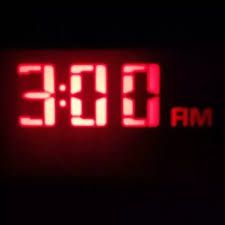 a digital clock displaying the time at 3 00 pm on a black background with red letters