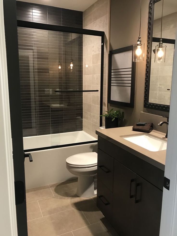 a bathroom with a white toilet sitting next to a bath tub and a walk in shower