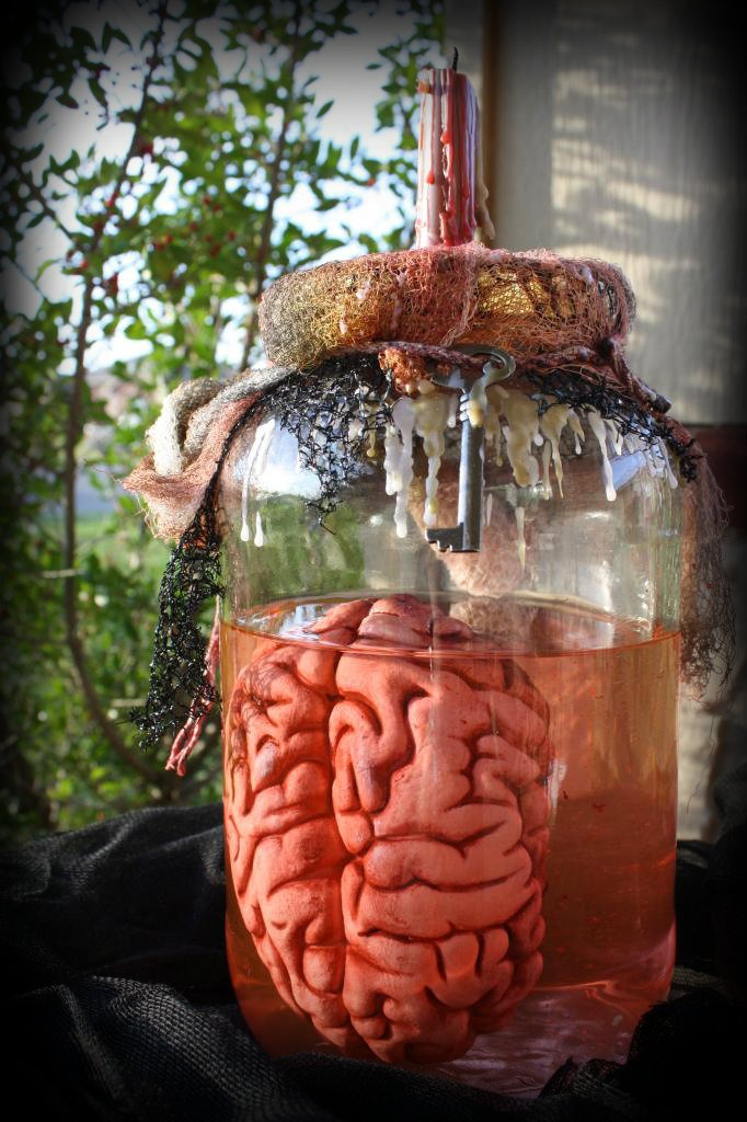 a jar filled with liquid and a human brain inside